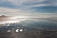 beach of water reflecting blue sky beach of water reflecting blue sky